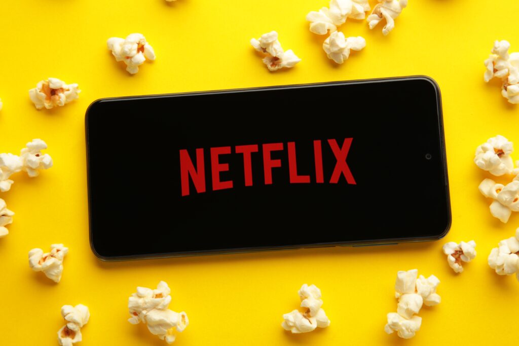 A vibrant collage of critically acclaimed Netflix original films, each featuring a “100%” Rotten Tomatoes badge and cinematic stills.